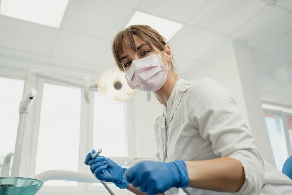 Dental professional preparing instruments for a patient during a dental appointment